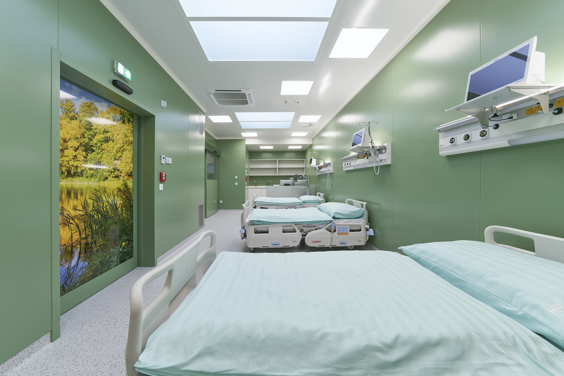 Bright green recovery room with hospital beds