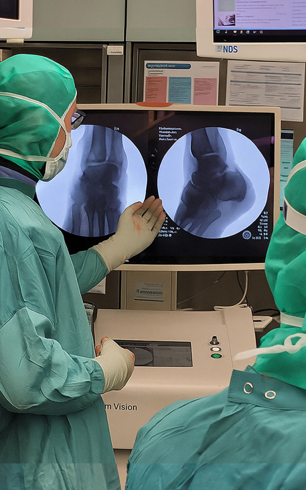 Surgeons analyzing an ankle X-ray during surgery